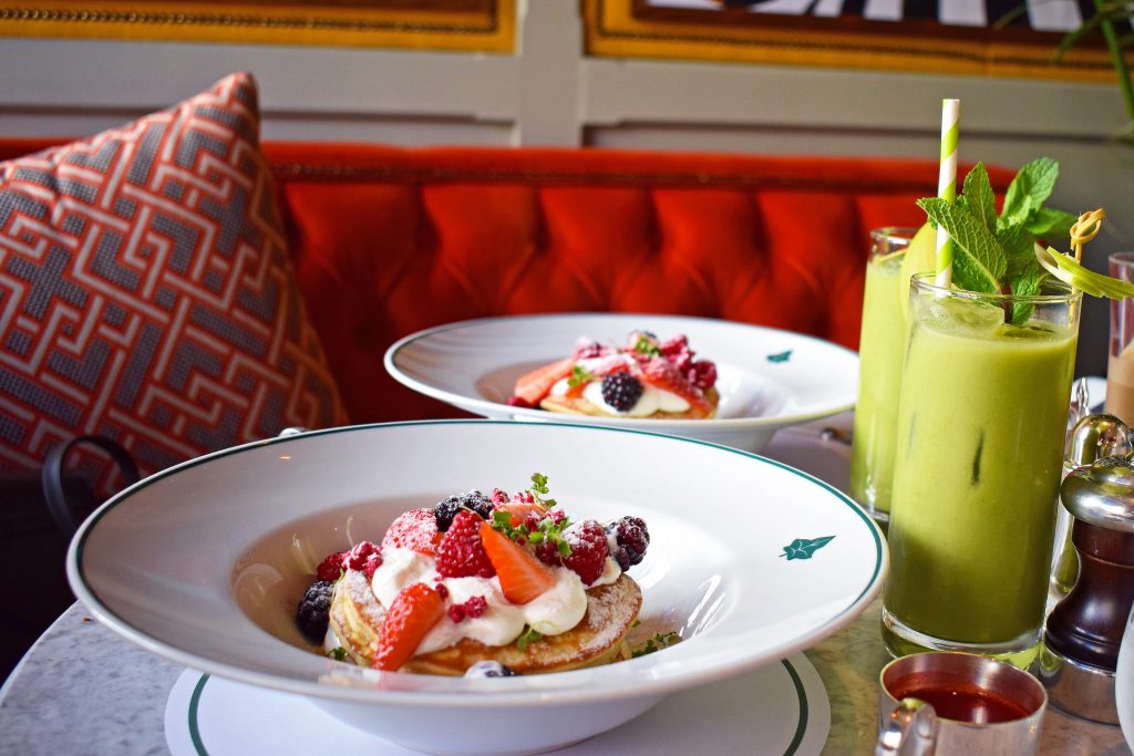 Breakfast at The Ivy: Two plates of pancakes and green juices Breakfast at The Ivy: Two plates of pancakes and green juices